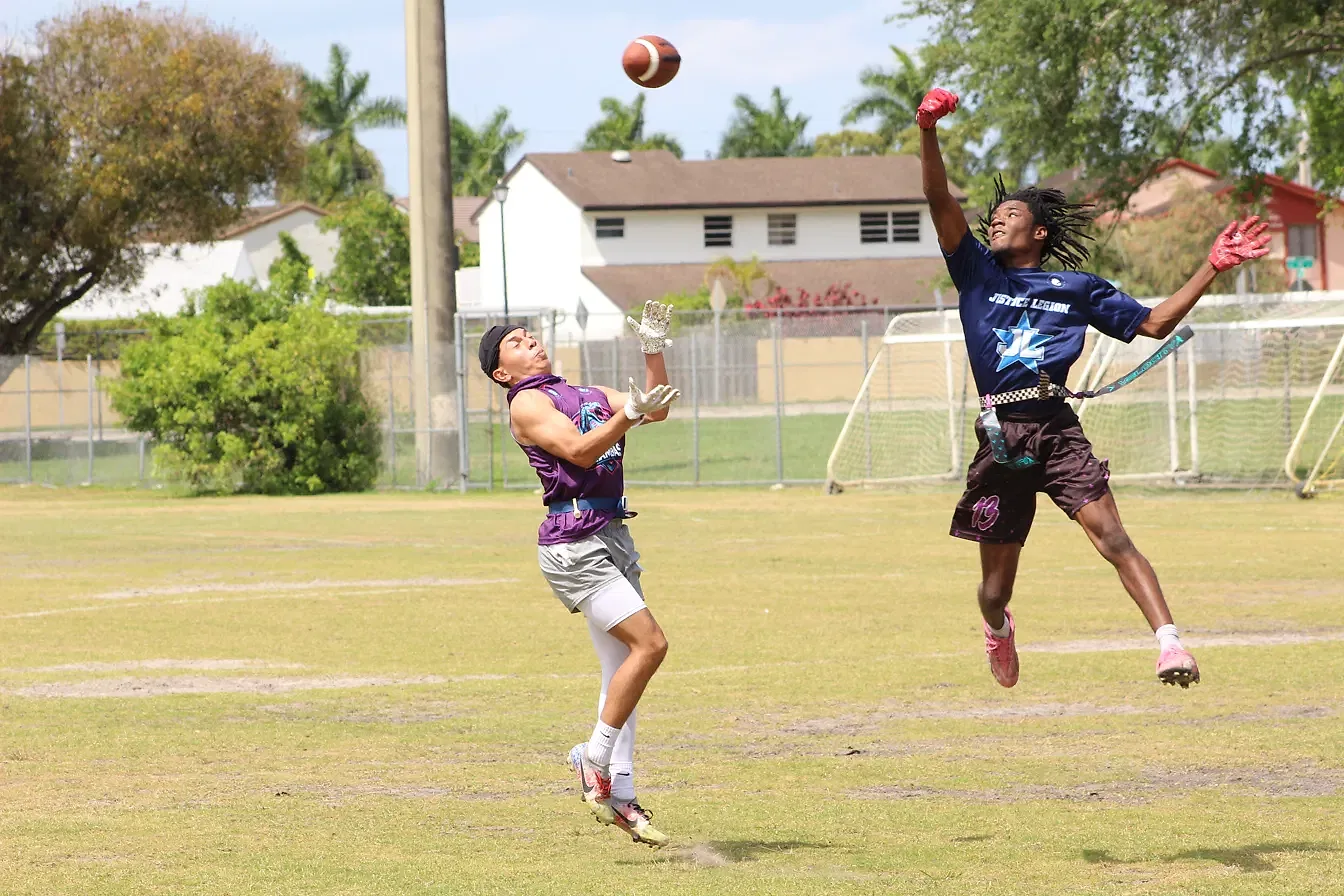 Two players elevate to contest a deep pass